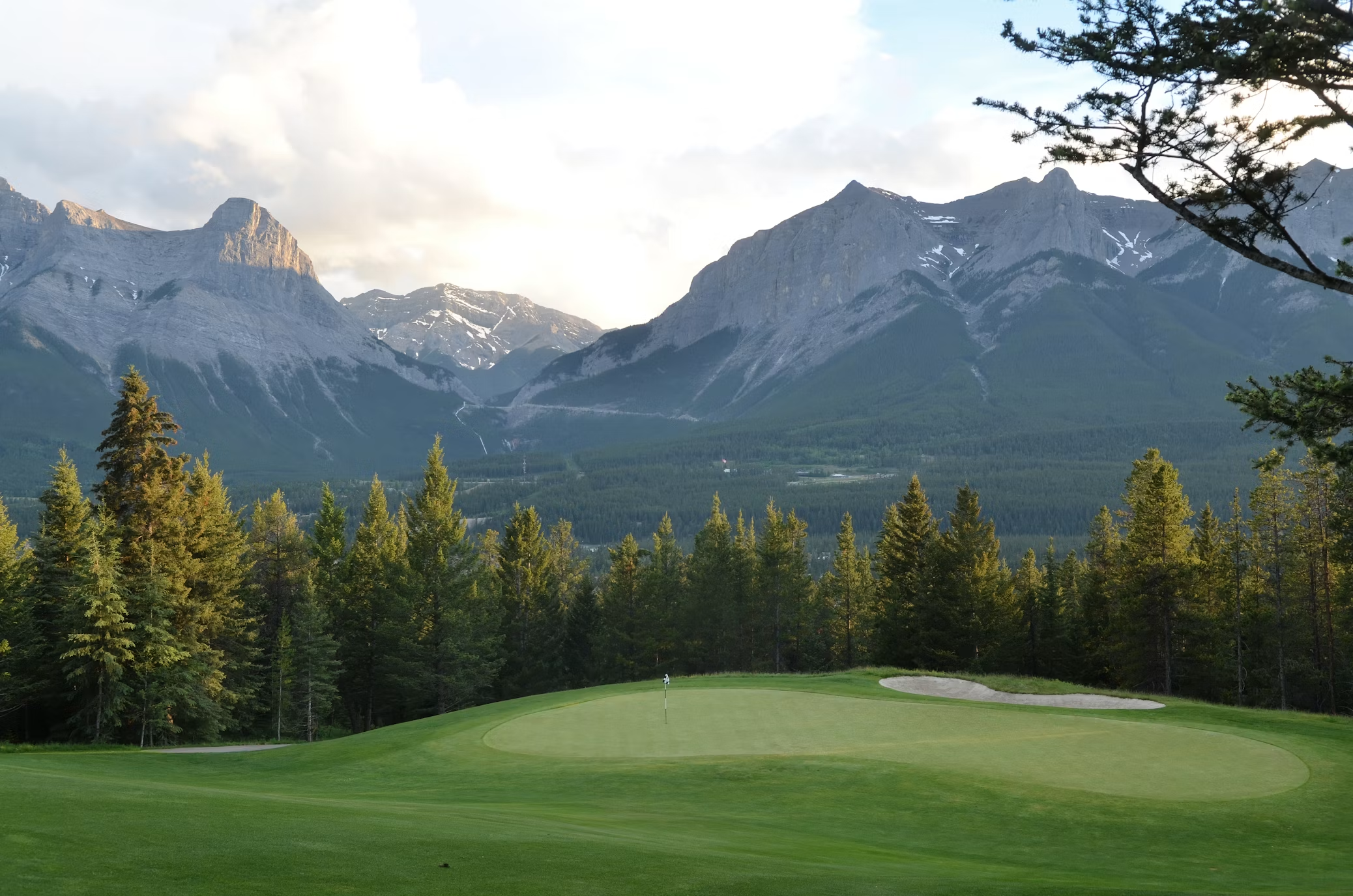 Golf green with dramatic Rocky Mountain backdrop